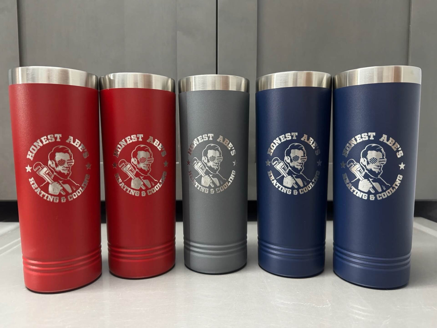 A set of engraved thermoses.